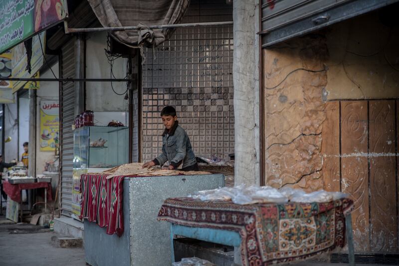 A boy lays out bread in Raqqa. Photograph: Sally Hayden