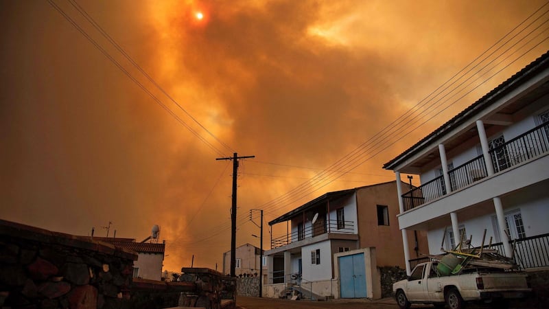 Heavy smoke covers the sky above the village of Ora in the southern slopes of the Troodos mountains, as a giant fire rages in Cyprus. Photograph: Andrea Anastasiou/AFP via Getty Images