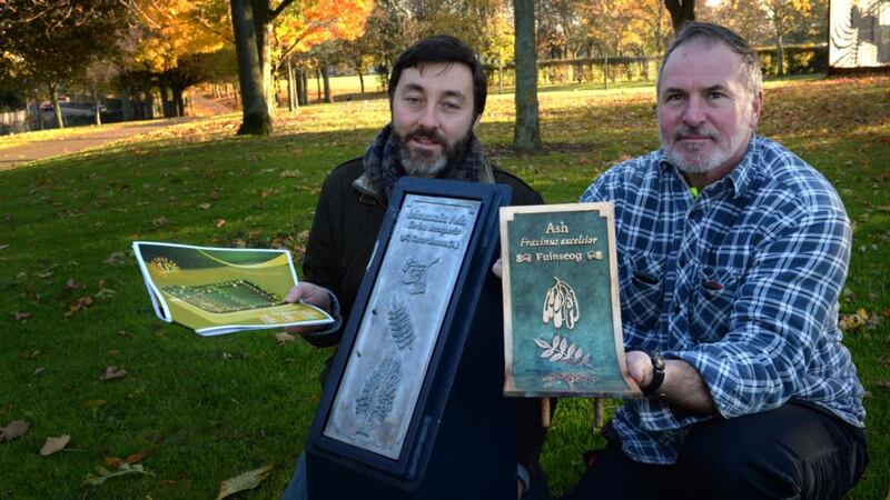 Tree trail: Sean Redmond and Donal O’Connor of Markievicz Park in Ballyfermot, west Dublin, with tree nameplates. The original bronze plates, in O’Connor’s hands, were stolen from Bushy Park and Markievicz Park. Photograph: Cyril Byrne