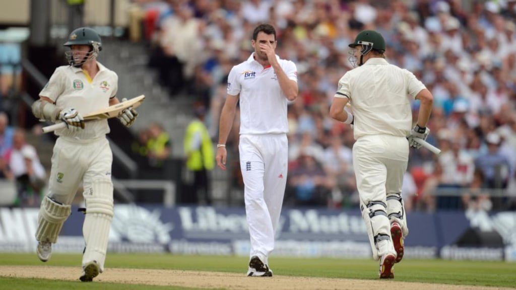 England’s James Anderson reacts as Australia’s Chris Rogers and Shane Watson take a run during the first day of the third Ashes testat Old Trafford. Photograph: Philip Brown/Reuters