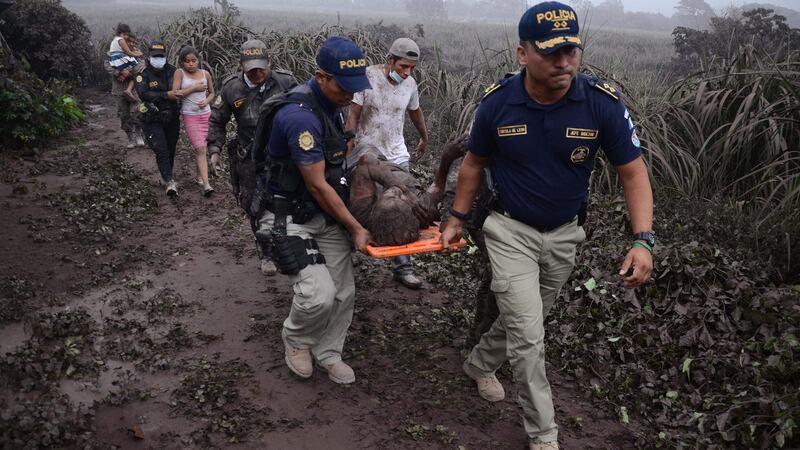 Police carry a wounded man after the eruption of the Fuego Volcano. Photograph: Getty