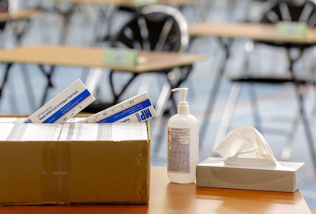 Anti-Covid 19 hydro-alcholic gel and antigen test cards  laid out during the preparations for the final exams at a secondary school in The Hague. Photograph: Robin van Lonkhuijsen/Getty Images