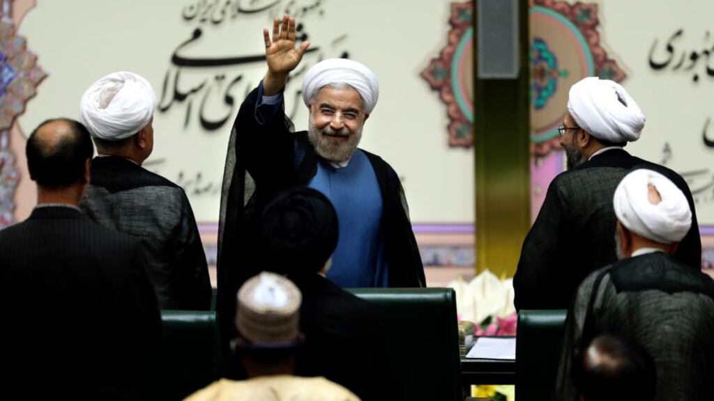 Iranian president Hassan Rouhani waves after his swearing-in at the parliament in Tehran yesterday. Photograph: AP Photo/Ebrahim Noroozi