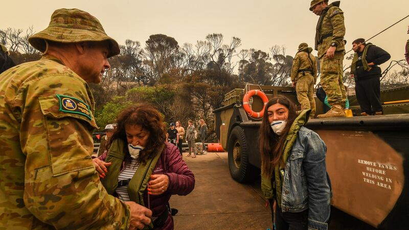 People stranded in Mallacoota, Victoria are evacuated by army personnel after bushfires ravaged the town. Photograph:  Justin McManus/The Age/Fairfax Media via Getty Images