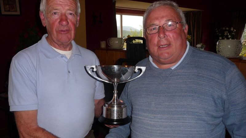 Stuart McGrane, left, receiving the Wicklow Cup following his win on Mask from club vice-chairman, Brian Byrne.