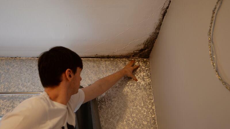 Paul Hanevy points out mildew on external walls of his Pearse House flat. Photograph: Alan Betson