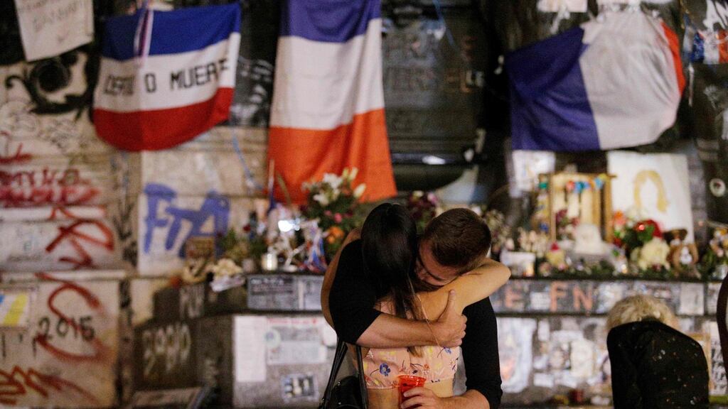 People stand in front of the Place de la Republique monument in Paris, after a priest was killed in the Normandy city of St-Étienne-du-Rouvray in the latest attack claimed by Islamic State. Photograph: Geoffroy Van Der Hasselt/AFP/Getty Images