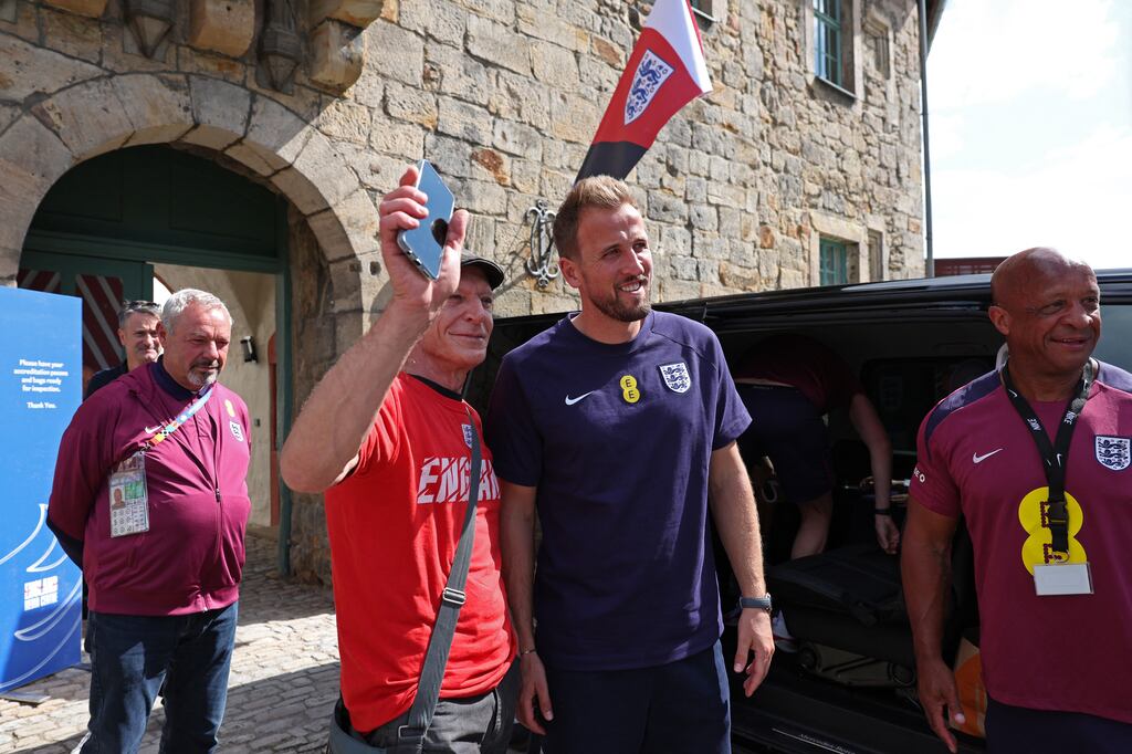 Harry Kane poses with a fan after addressing a press conference of England national team at their base camp in Blankenhain. Photograph: Adrian Dennis/AFP via Getty Images