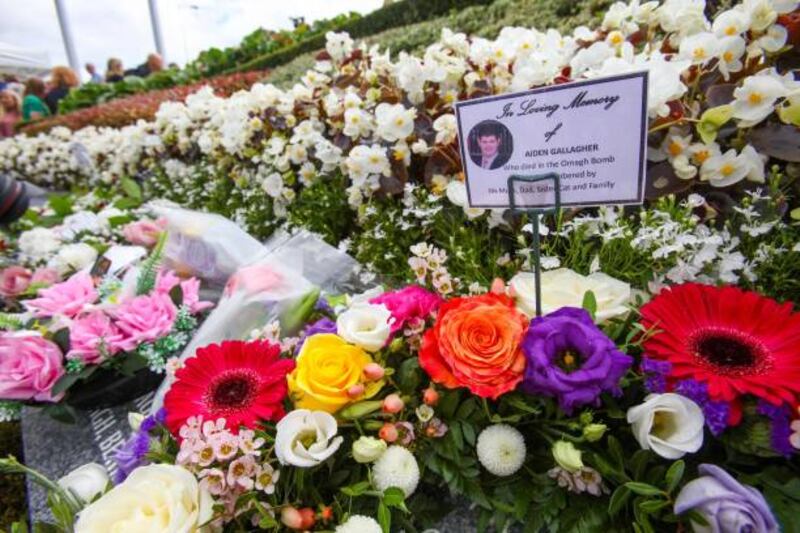 Floral tributes to those killed in the Omagh bomb attack are seen in the memorial garden at a service on the 25th anniversary of the Omagh bombing, in tribute of the victims, in the city centre of Omagh, on Sunday. Photograph: Paul Faith/AFP via Getty Images
