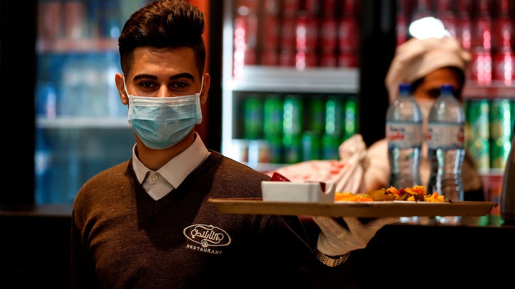 Restaurant staff in Gaza City, operating under Covid-19 regulations. File photograph: Mahmud Hams/AFP via Getty Images