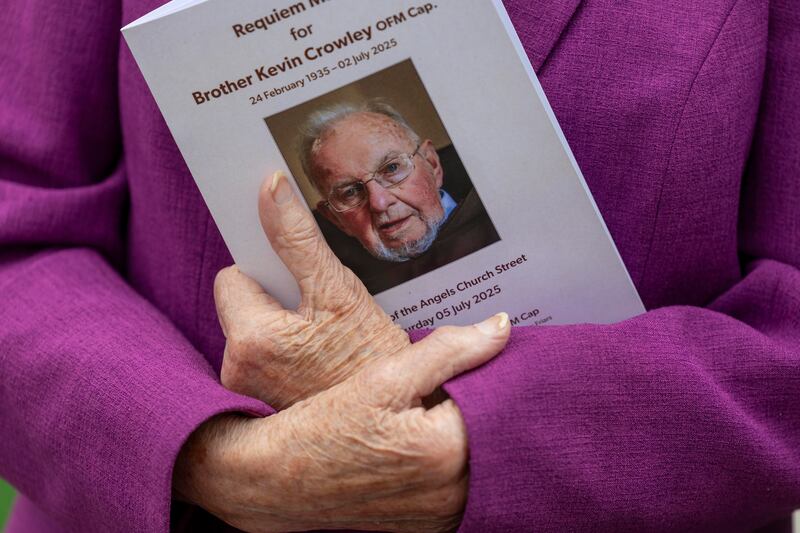 A mourner holds a funeral booklet for Br Kevin Crowley. Photograph: Tom Honan
