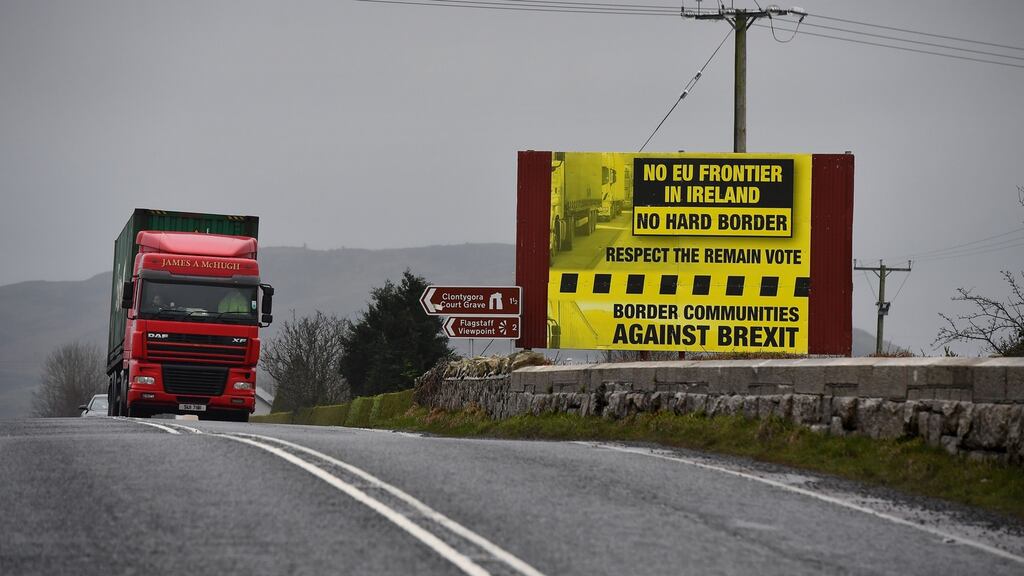 Border sign: a truck near Newry passes a campaigning poster. Photograph: Charles McQuillan/Getty