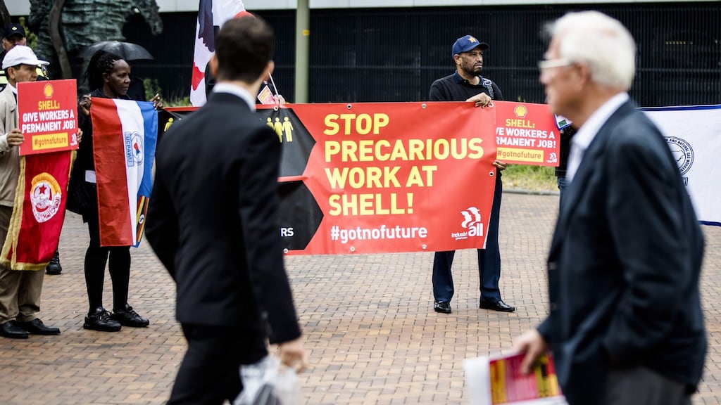 People hold a protest as members of the board of the petrochemical company Shell hold their agm at the Circus theater in The Hague