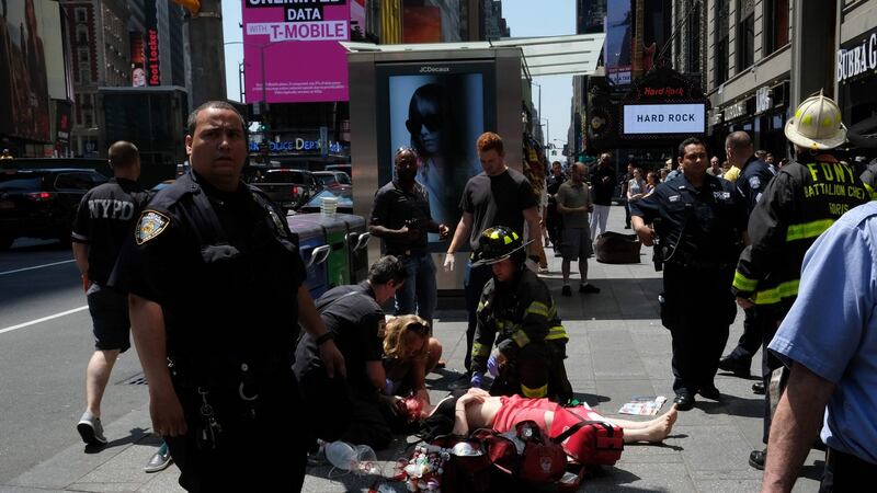 First responders attend to an injured woman after a car plunged into pedestrians in Times Square in New York on May 18th. Photograph: /Jewel Samad/AFP/Getty