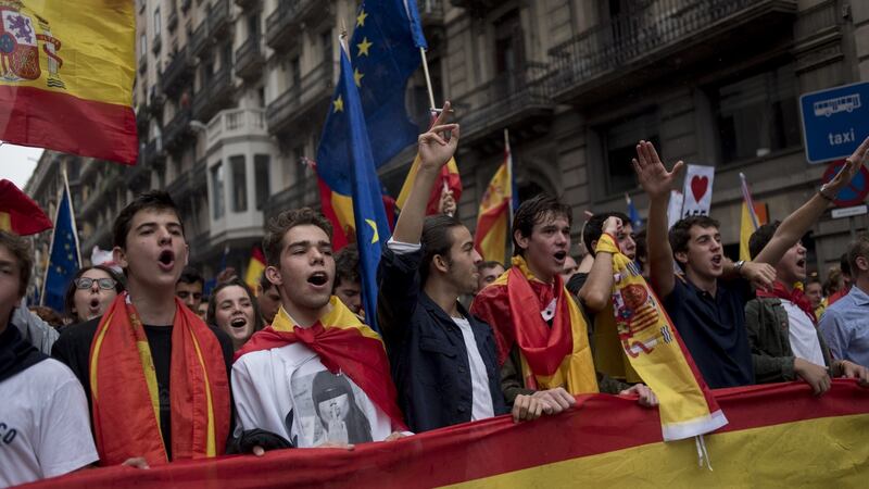 Anti-separatist demonstrators march with Spanish flags during a rally against the Catalonian independence referendum at Placa Sant Jaume in Barcelona, Spain. Photograph: Geraldine Hope Ghelli/Bloomberg