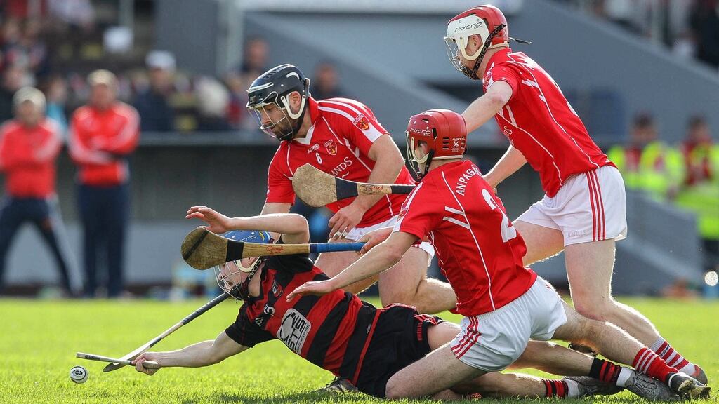 Ballygunner’s Tim O’Sullivan is tackled by Passage’s Darragh Lynch and Noel Connors. Photo: Ken Sutton/Inpho