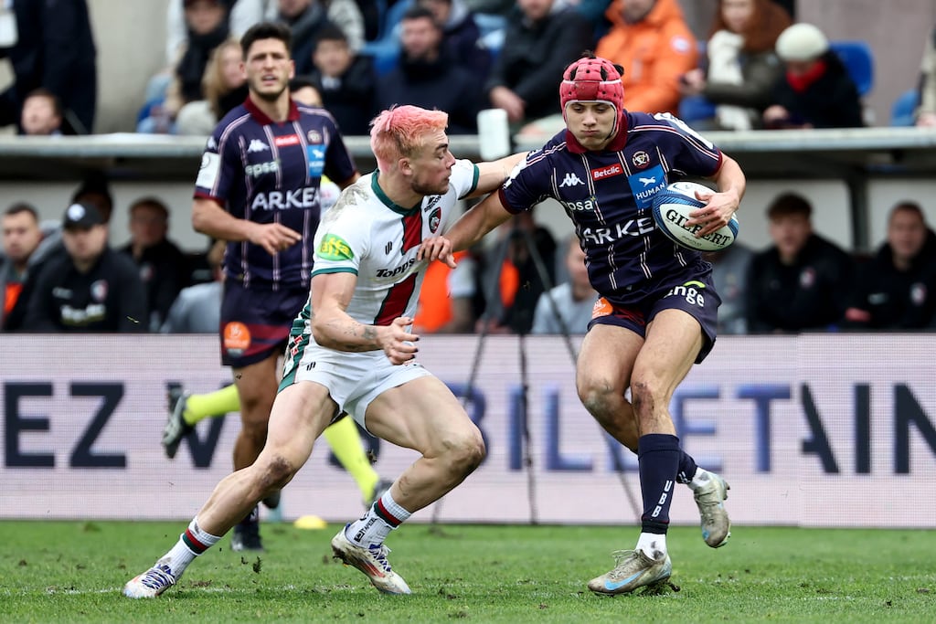 Leicester' British wing Ollie Hassell Collins (L) tackles Bordeaux' French full back Louis Bielle Biarrey (R) during the European Rugby Champions Cup pool 1 match between Union Bordeaux-Begles (UBB) and Leicester Tigers at The Chaban-Delmas Stadium in Bordeaux on December 8, 2024. (Photo by ROMAIN PERROCHEAU / AFP) (Photo by ROMAIN PERROCHEAU/AFP via Getty Images)