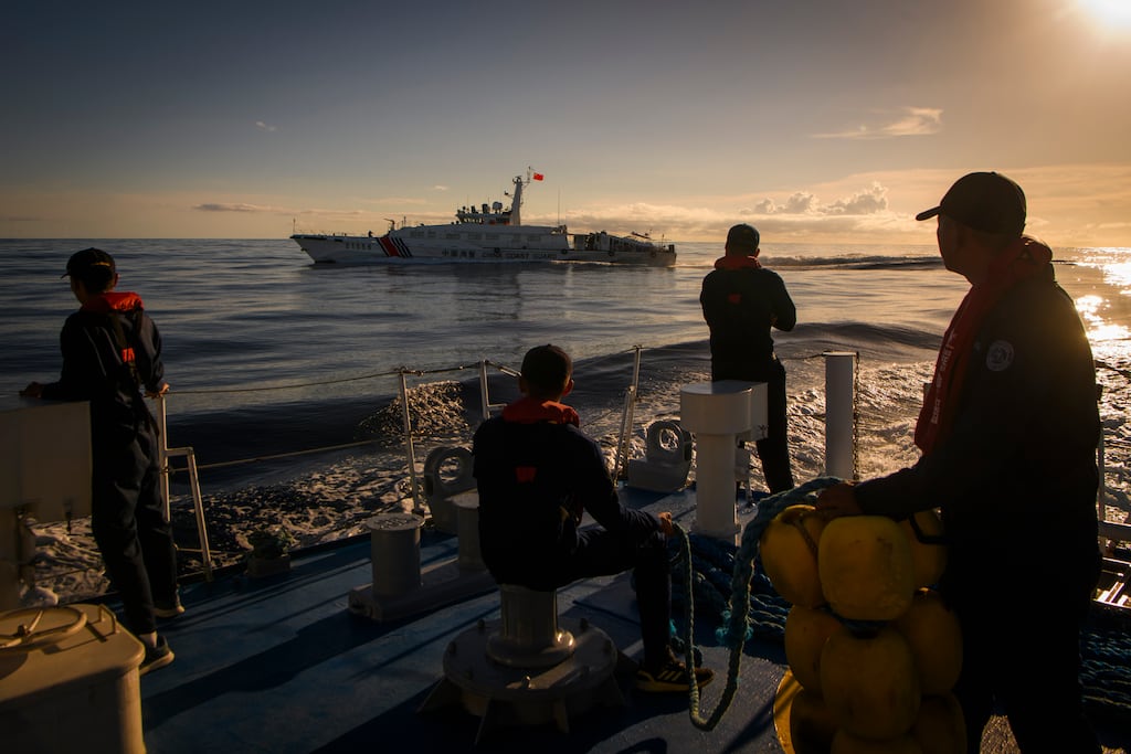 Chinese coast guard and militia ships chase Philippine coast guard vessels escorting a resupply mission to its outpost in the Spratly Islands in the South China Sea. Photograph: Jes Aznar/New York Times