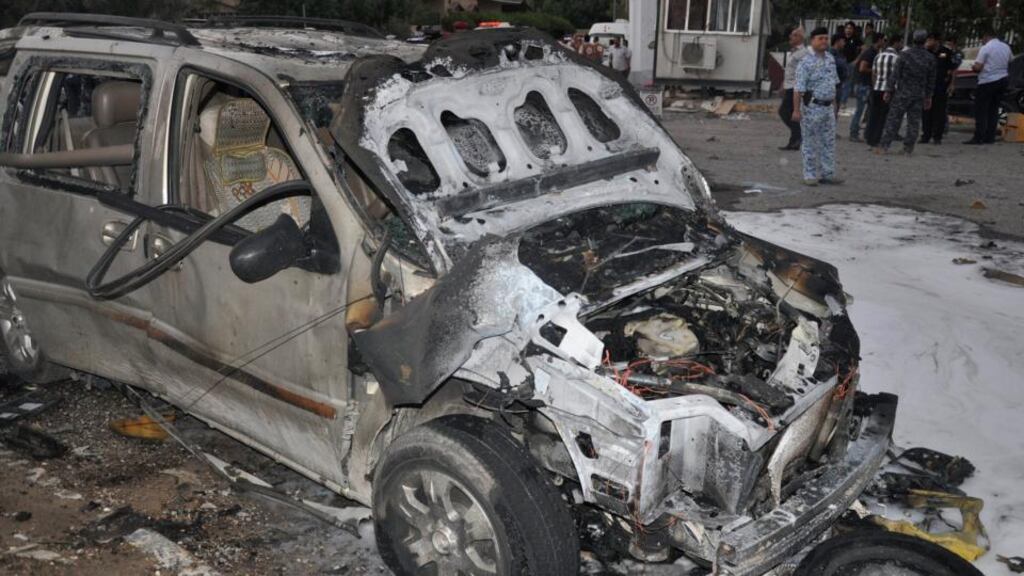 Iraqi security forces at the site of a car bomb attack in Basra, 420km  southeast of Baghdad, today. Photograph: Reuters