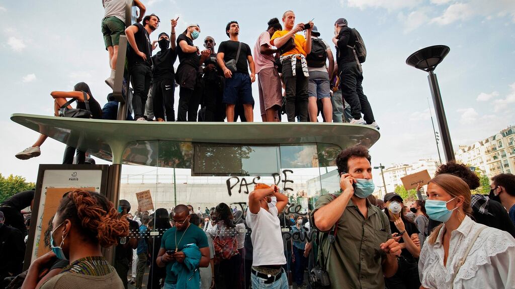 Protesters demonstrate in front of Paris courthouse against police violence. Some 20,000 people defied a ban in Paris  to protest the 2016 death of a young black man in French police custody. Photograph: Michael Rubinel/AFP via Getty Images