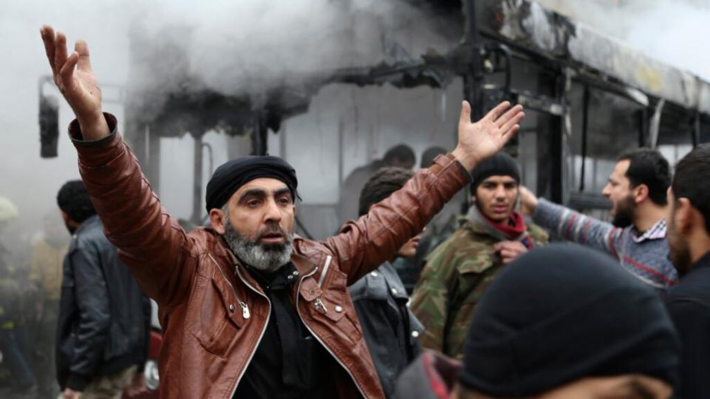 A man reacts after an explosion in a bus caused by what activists said was shelling from forces loyal to Syria’s president Bashar Al-Assad in Tariq Al Bab neighbourhood of Aleppo. Photograph: Ahmad Othman/Reuters