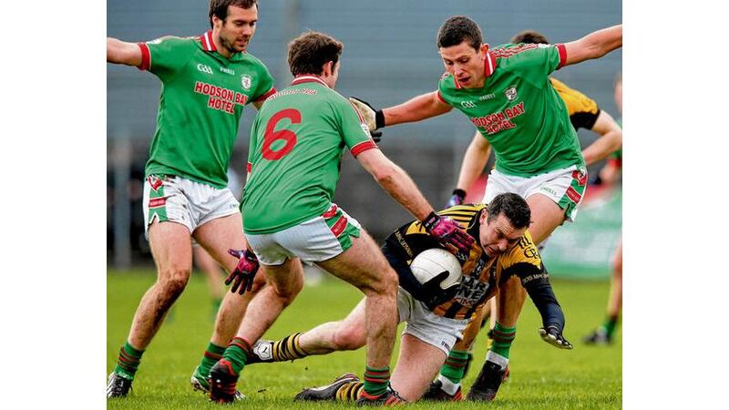 Crossmaglen's Oisín McConville struggles to break through the St Brigid's defence. Photograph: Inpho