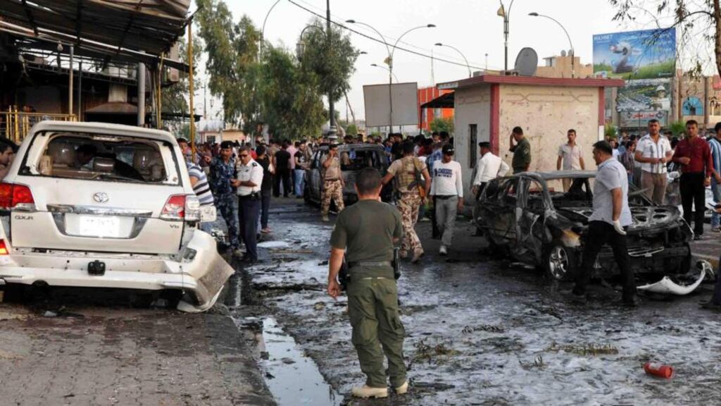 Iraqis gather at the scene of a car bomb attack in Kirkuk city, northern Iraq, where four people were reportedly killed and 15 others injured. Photograph: Khalil Al-A’nei/EPA