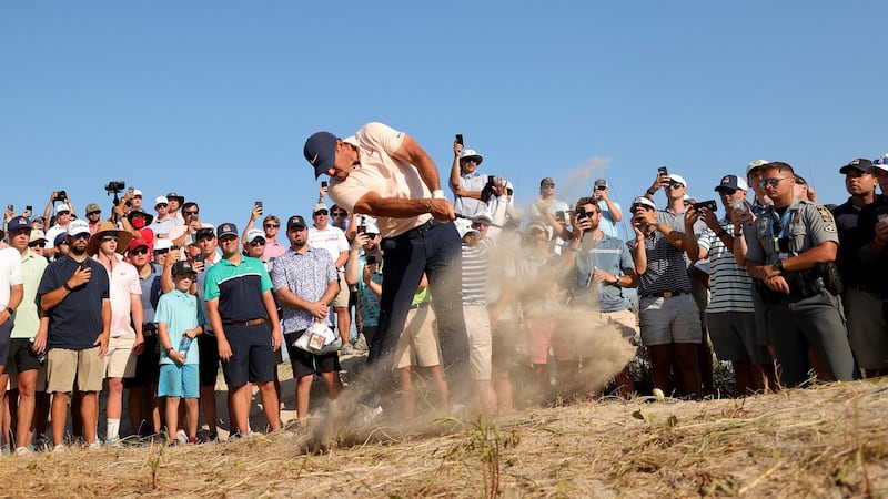 Brooks Koepka plays his second shot on the 13th hole. Photo: Stacy Revere/Getty Images