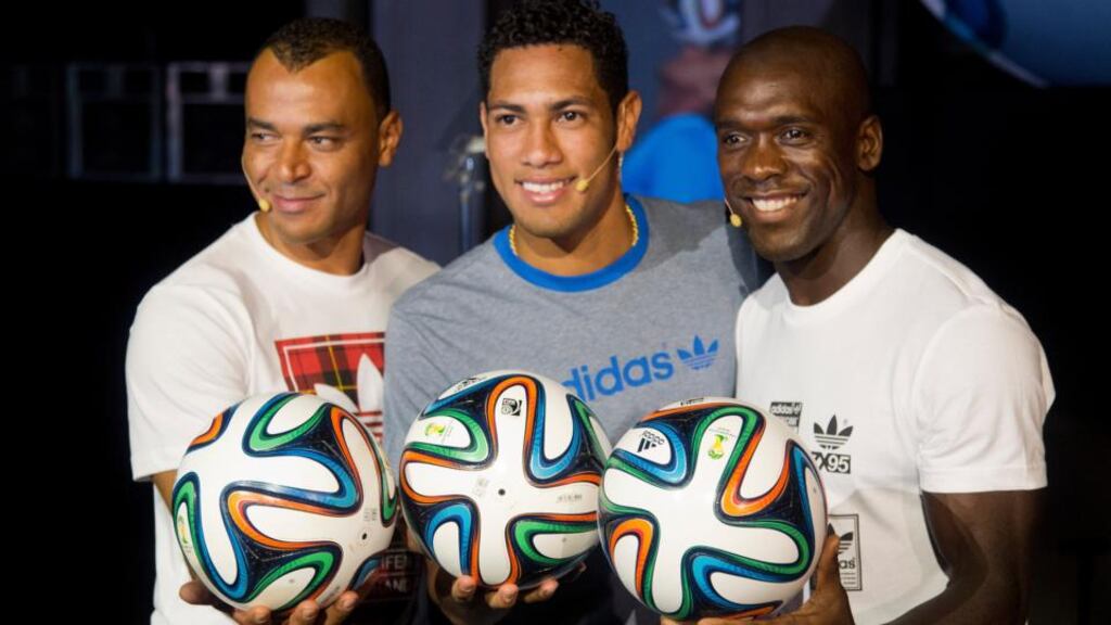 Former Dutch player Clarence Seedorf (right), Brazilian international Hernanes and former Brazilian player Cafu pose with the Brazuca. Photograph: Victor R Caivano/AP