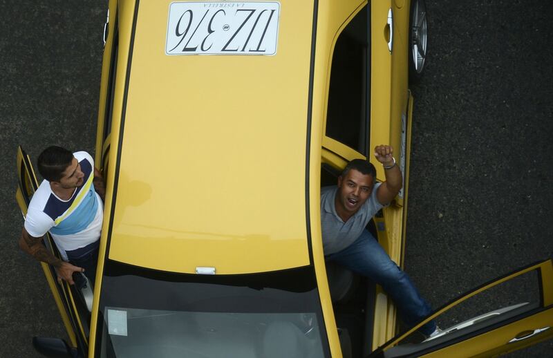 Thousands of taxi drivers gather in Bogota to protest against the Uber taxi-booking mobile app.