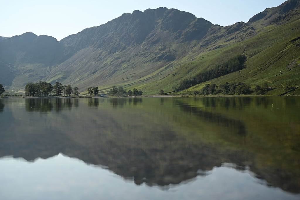 Hills are reflected in the water of Buttermere Lake early in the morning, in the Lake District in Cumbria, northwest England. Photograph: Oli Scarff/AFP via Getty Images