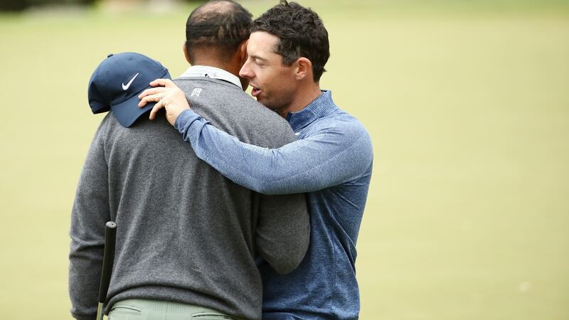 Tiger Woods embraces Rory McIlroy after defeating him 2&1. Photograph: Ezra Shaw/Getty Images