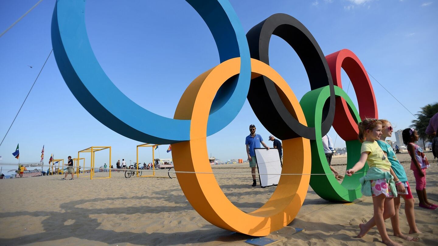 Children pose next to the Olympic rings on Copacabana beach in Rio. Photograph: AFP / Kirill Kudryavtsev / Getty Images