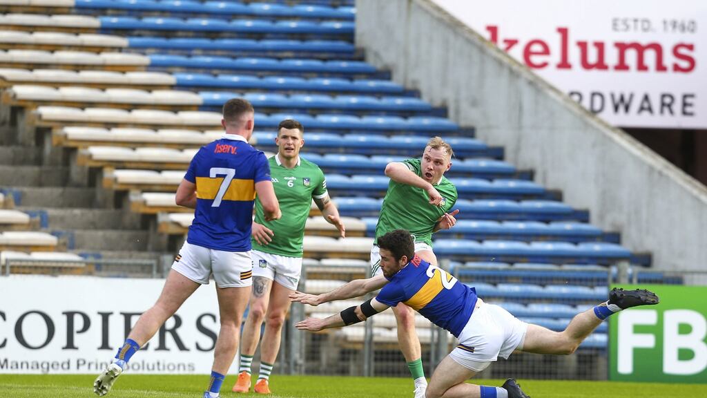 Tipperary’s Shane O’Connell dives to block a shot from Limerick’s Adrian Enright. Photograp: Ken Sutton/Inpho