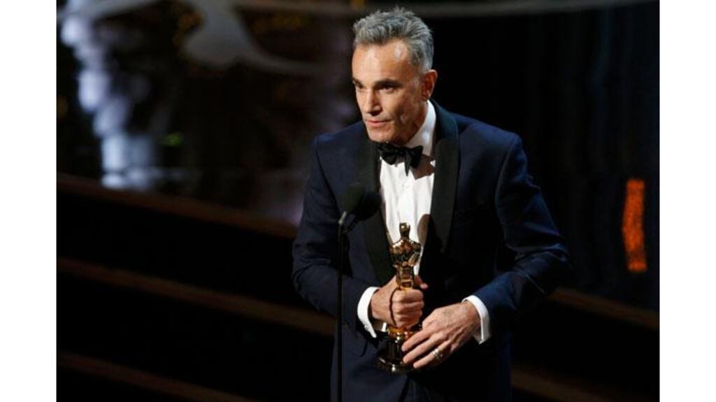 Daniel Day-Lewis accepts the Oscar for best actor for his role in Lincoln at the 85th Academy Awards in Hollywood, California, last night. Day Lewis is the first actor to win three best actor Oscars. Photograph: Mario Anzuoni/Reuters