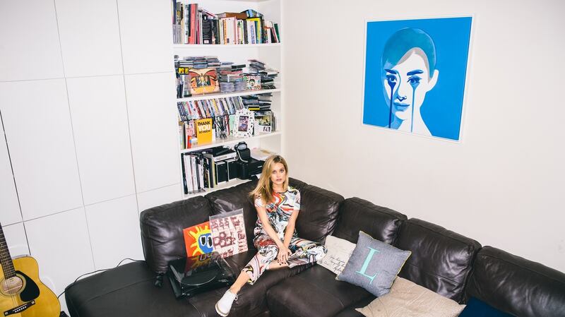 Laura Whitmore in her Camden flat, with her painting of Audrey Hepburn by graffiti artist Pure Evil.