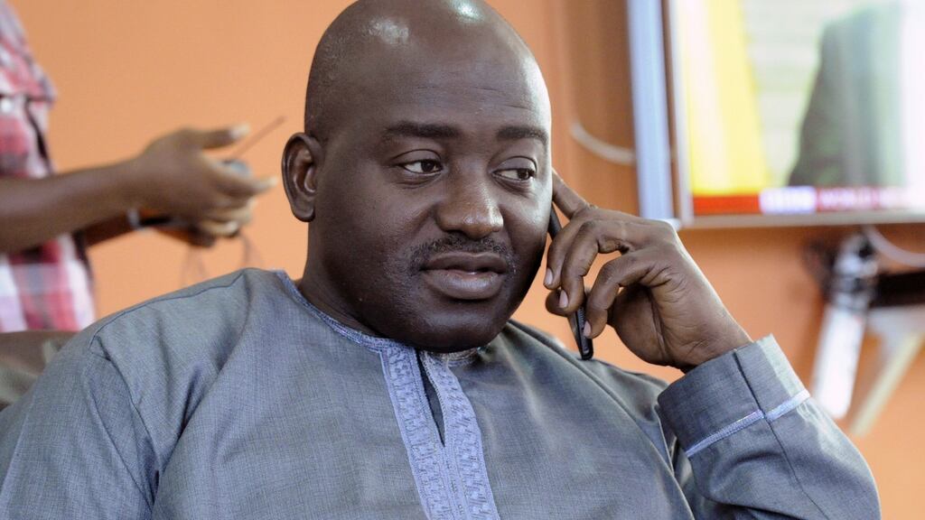 Liberia FA chairman Musa Bility speaks on his mobile phone after annoucing plans to stand for the presidency of Fifa. Photo: Zoom Dosso/Getty Images