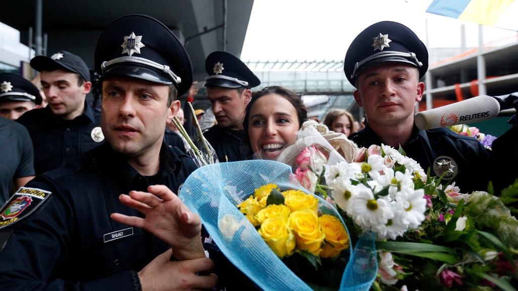 Ukraine’s Jamala, surrounded by policemen, waves to supporters upon her arrival at Borispil international airport outside in Kiev, Ukraine, on Sunday after winning the Eurovision song contest on Saturday. Photograph: Sergei Chuzavkov/AP Photo