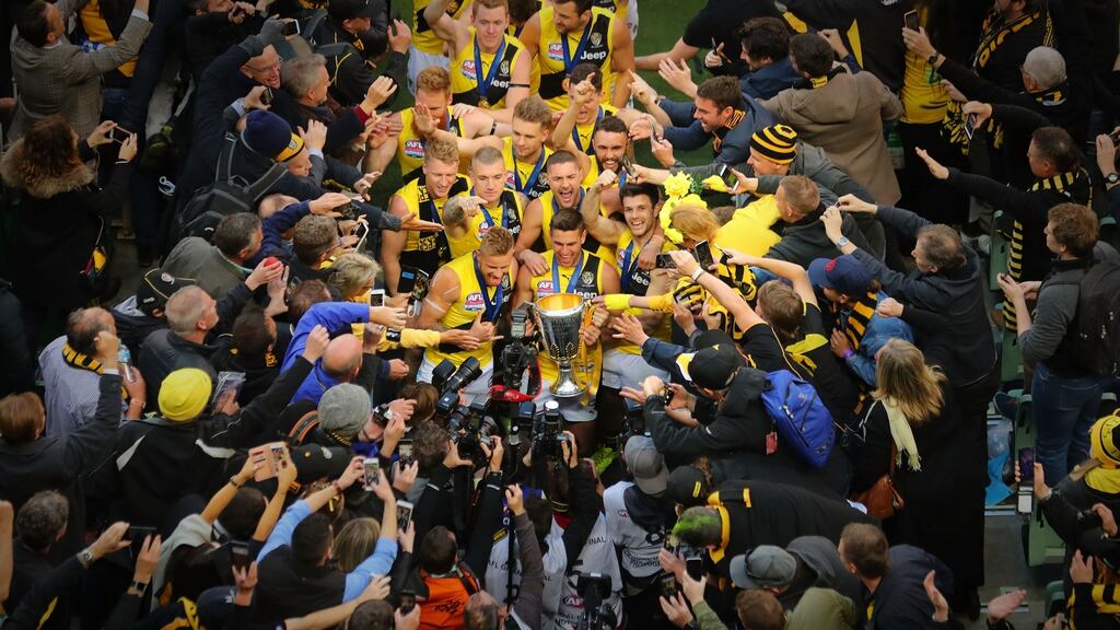 Richmond Tigers celebrate with the the AFL Premiership Cup after winning the 2017 AFL Grand Final against the Adelaide Crows at the Melbourne Cricket Ground. Photograph: Scott Barbour/AFL Media/Getty