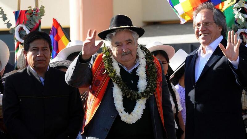 Uruguay’s president Jose Mujica (centre) accompanied by Bolivia’s foreign minister David Choquehuanca (left) and Uruguay’s foreign minister Luis Almagro wave upon their arrival at Cochabamba. Photograph: Danilo Balderrama/Reuters