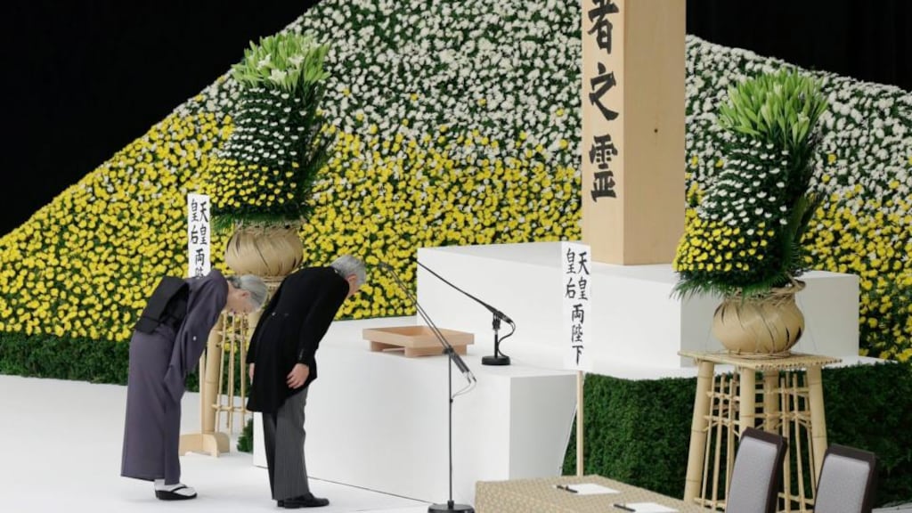 Japanese emperor Akihito (right) and empress Michiko bow before an altar during a memorial service at Nippon Budokan Hall in Tokyo, Japan, 15th August 2015. Photograph: Kiyoshi Ota/EPA