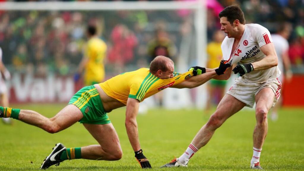 Tempers flair between Donegal’s Neil Gallagher and Seán Cavanagh of Tyrone. Photo: Cathal Noonan/Inpho