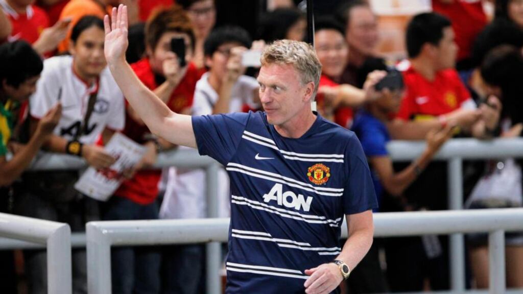 Manchester United manager David Moyes waves to fans before their friendly soccer match against the Thailand Singha All Stars at the Rajamangala national stadium in Bangkok. Photograph: Chaiwat Subprasom/Reuters