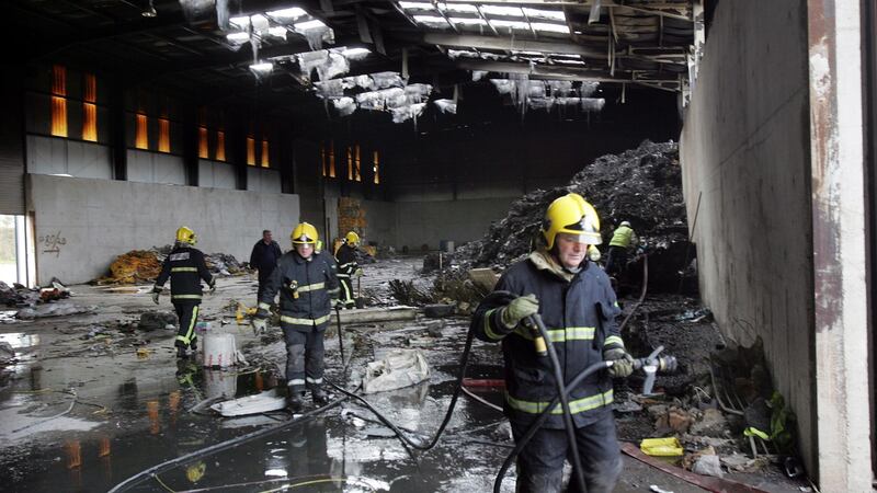 Fire fighters from Kildare Fire Service and officials from the EPA at the scene of a fire in a storage facility at Kerdiffstown landfill site in 2010. Photograph : Matt Kavanagh/The Irish Times