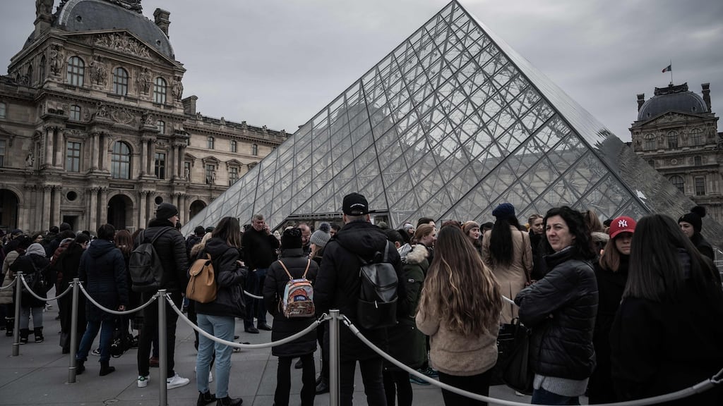 Visitors queue outside the Louvre museum in Paris after staff ended coronavirus walkout following two days of closure. Photograph: Philippe Lopez/ AFP