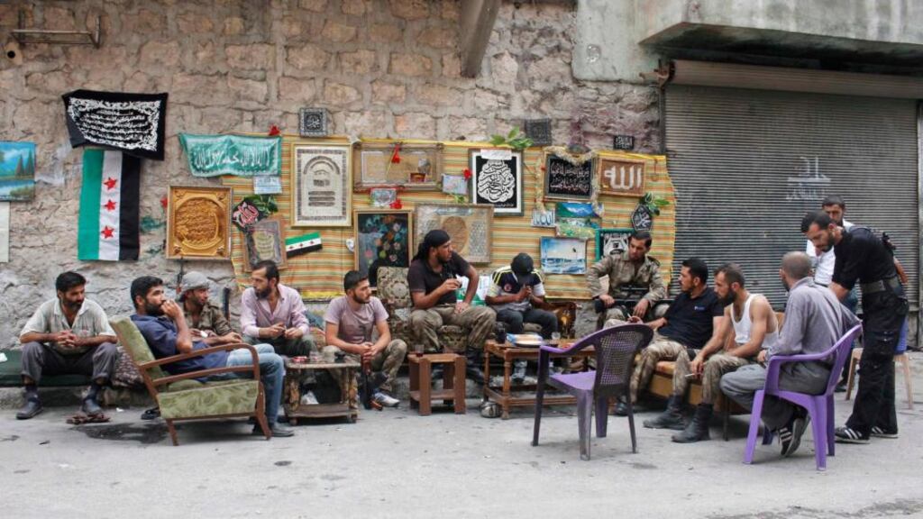 Members of the “Liwaa al-Sultan Mrad” brigade, operating under the Free Syrian Army, sit together as they rest in Aleppo – “Defeating the regime was actually possible until the first months of this year.”PHOTOGRAPH: REUTERS/MOLHEM BARAKAT