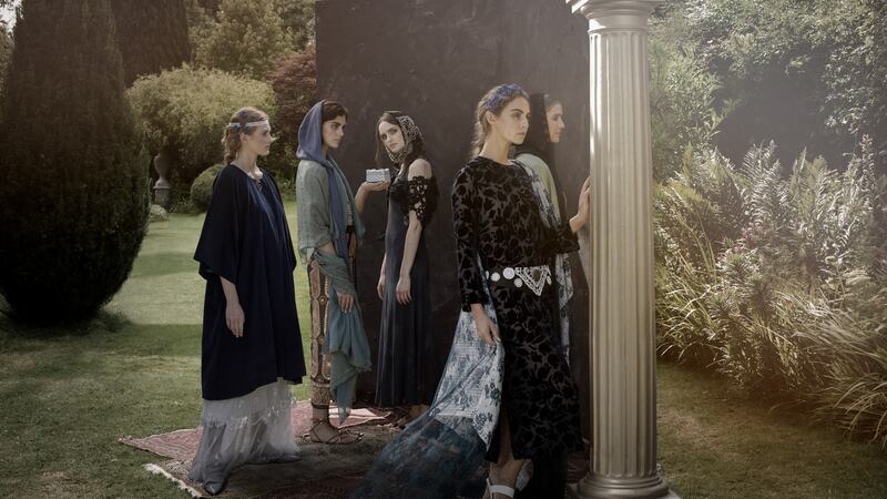 Second panel. Etain: Aine wears fine blue cord kimono over white silk satin dress and antique lace frill skit. White lace and blue crochet headdress. Helen: Abby wears blue and gold embroidered wrap skirt, gold lame wrap top, blue cotton handknit hooded scarf and turquoise and green silk chiffon wrap. Maeve: Maria wears navy blue beaded slip dress with hand crochet lace shrug and silver lace headdress. Deirdre: Thalia wears blue silk devore dress with black silk appliqued belt and antique white lace shawl. Blue crochet headdress. Fand: Teo wears long black handknit cardigan with black lurex handkit hooded scarf. Aqua silk slip dress and pale green antique lace skirt and embroidered greens silk shawl. Photograph: Barry McCall