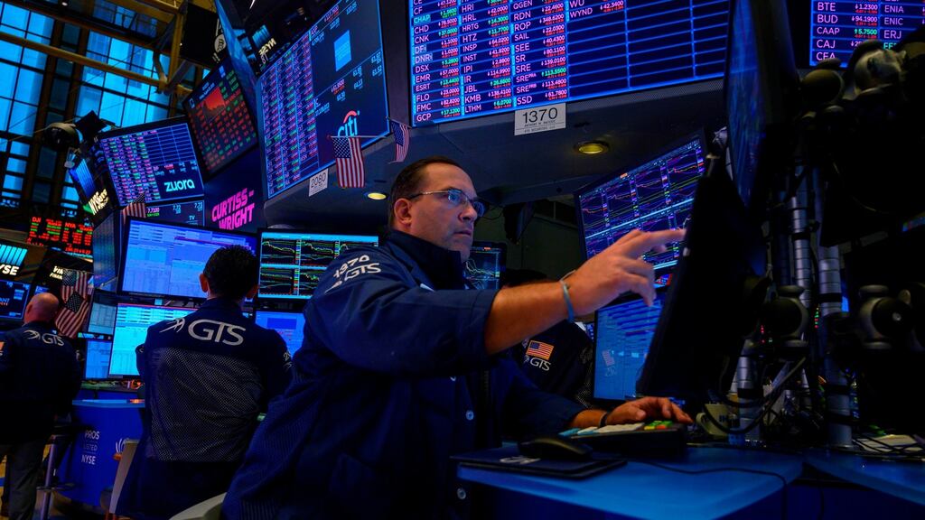 Traders work the floor of the New York Stock Exchange. Photograph: Don Emmert/AFP/Getty Images