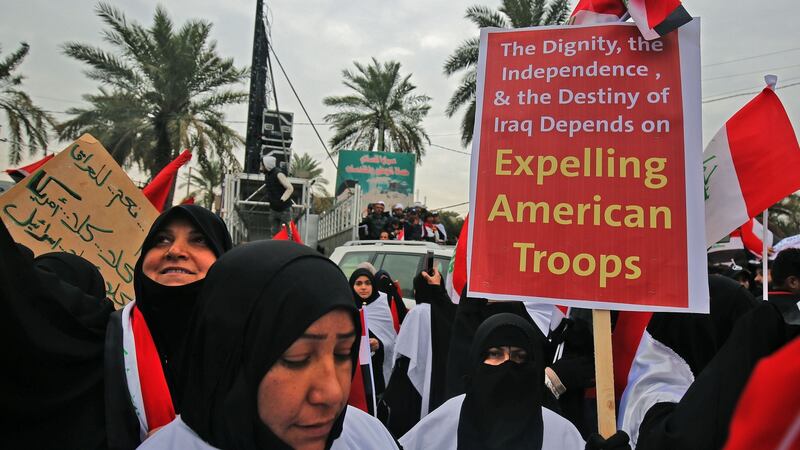 Women raise placards during the demonstration in Baghdad. Photograph: Ahmad Al-Rubaye/AFP via Getty Images