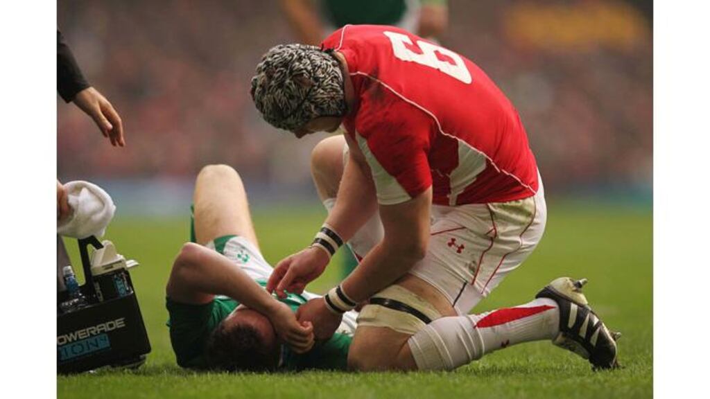 Wales flanker Dan Lydiate checks on Ireland scrumhalf Eoin Reddan in the first minute of their Six Nations encounter at the Millennium Stadium on March 12th, after the Leinster man was struck in the face by a clearance kick from the homeside. - (Photograph: Billy Stickland/Inpho)